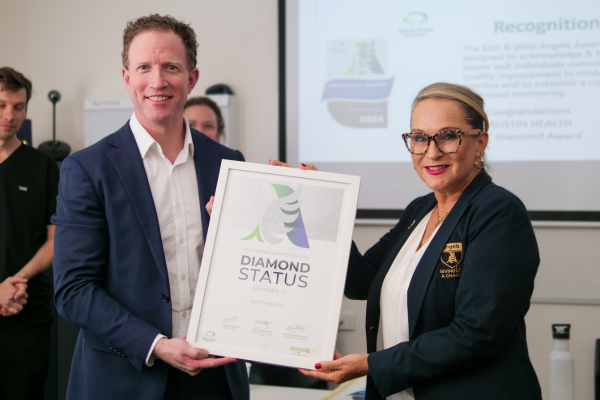 Austin Health CEO (Interim) Cameron Goodyear and Angels Initiative representative Samantha Dagasso holding framed certificate of WSO Angels Diamond Award awarded to Austin Health for excellence in stroke care.